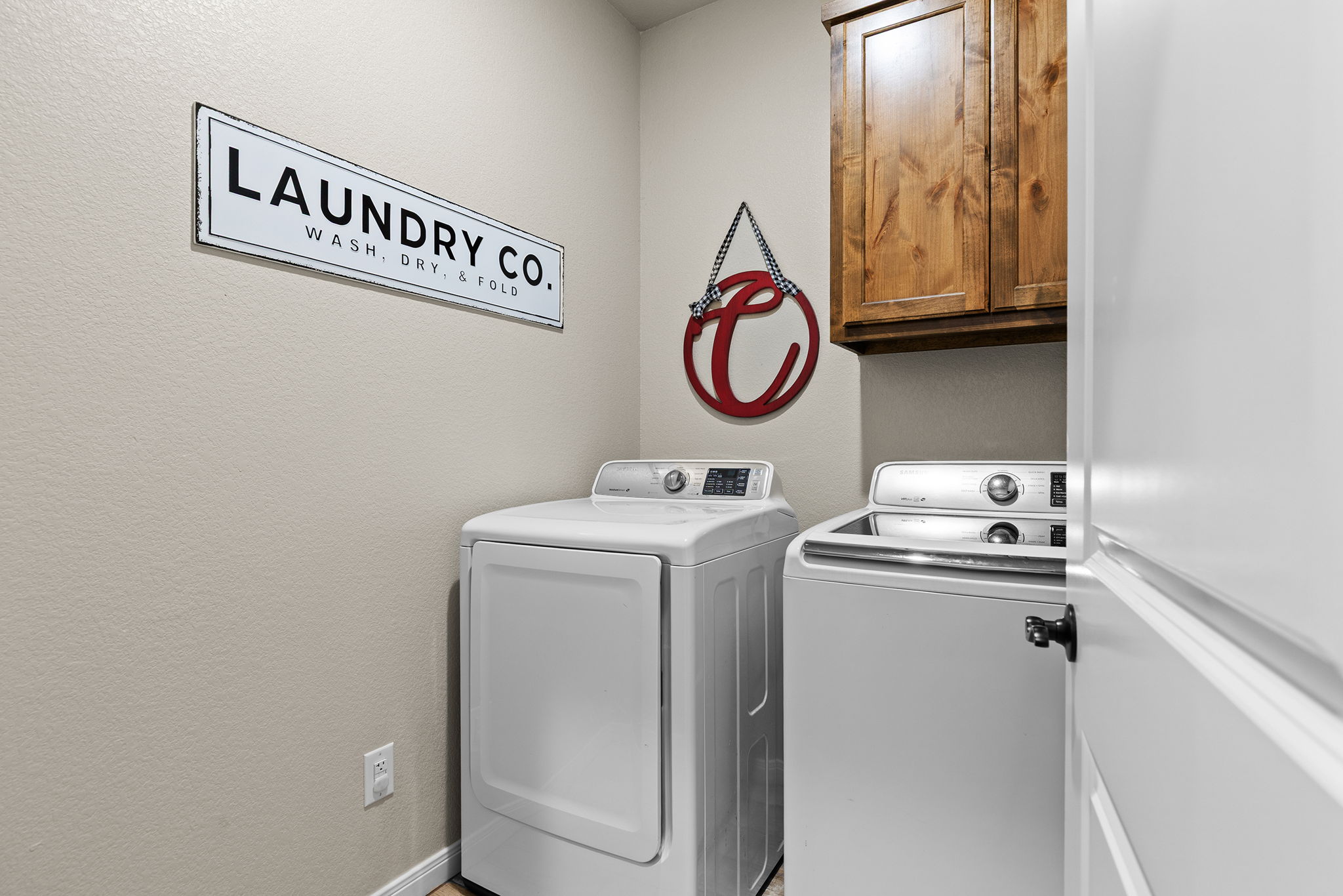 161 Greg Lane Jarrell, TX 76537 - Photo 25 of 35 Laundry area with overhead wood cabinetry