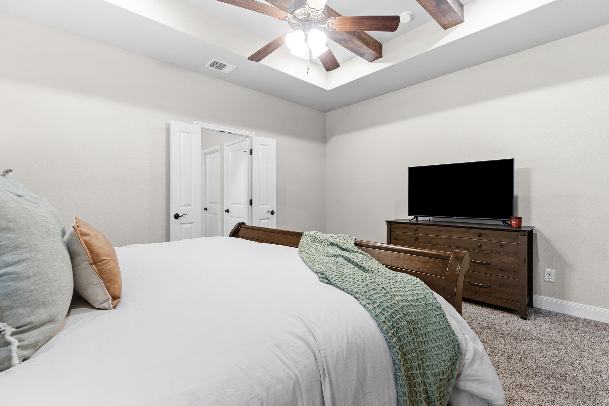 161 Greg Lane Jarrell, TX 76537 - Photo 28 of 35 Bedroom featuring a tray ceiling with a wood-finish fan, light gray wall paint, and white paneled doors