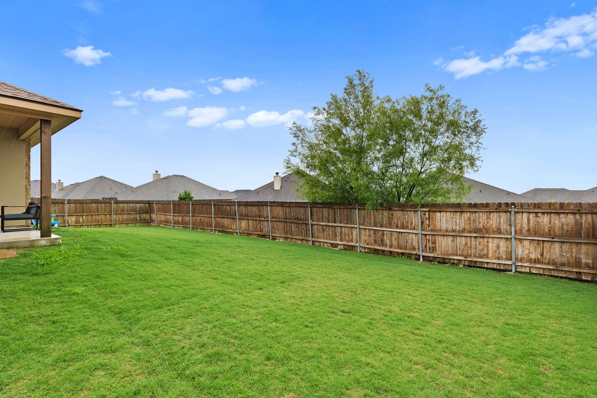 161 Greg Lane Jarrell, TX 76537 - Photo 35 of 35 Expansive green lawn with a full wood privacy fence