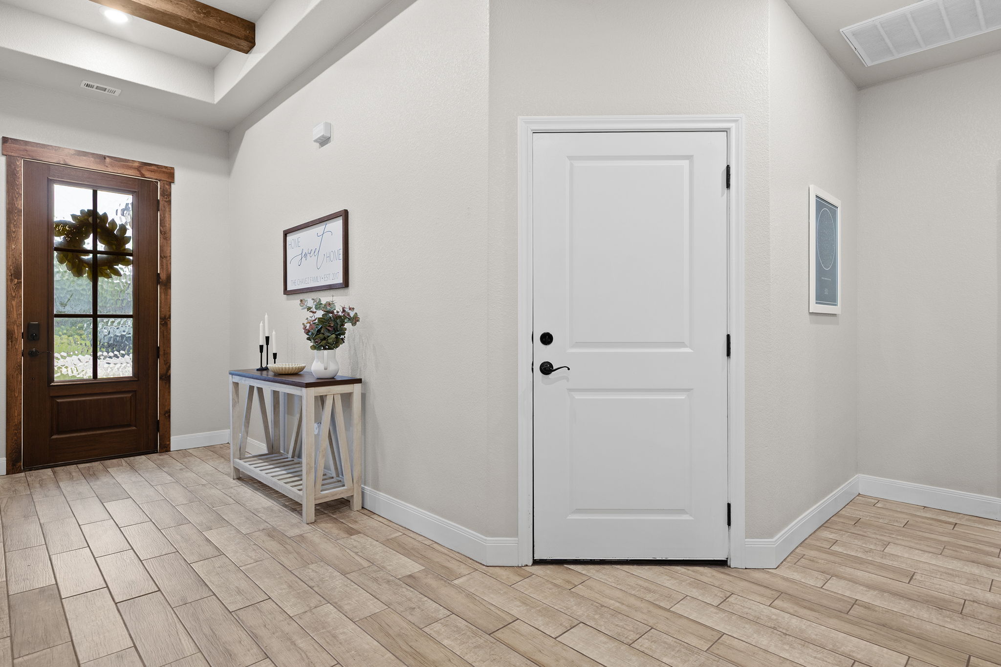161 Greg Lane Jarrell, TX 76537 - Photo 5 of 35 Entryway featuring wood-finish flooring, a dark wood-paneled entry door with decorative glass, and a coffered ceiling with exposed wood beams
