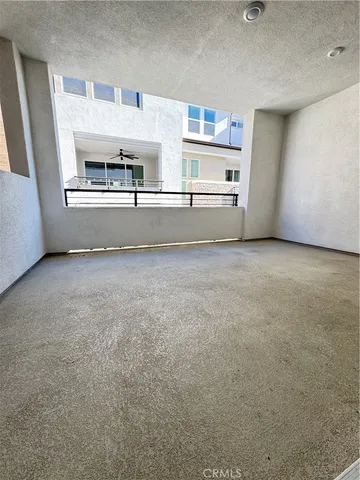 a view of a kitchen with a sink and a refrigerator