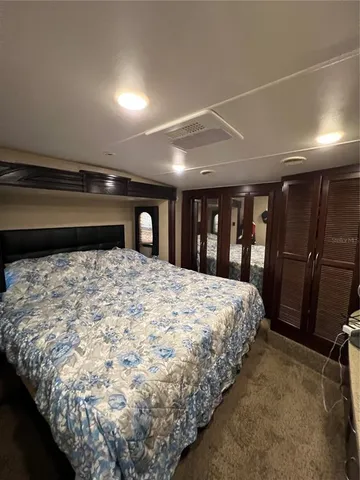 a large bed sitting in a room next to a window