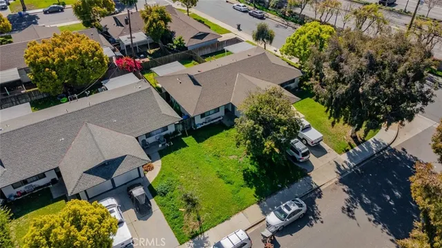 an aerial view of a house with a yard and garden