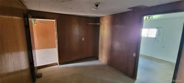 a view of a hallway to rooms and stairs