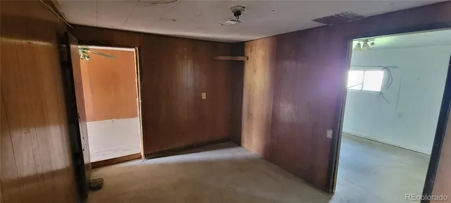 a view of a hallway to rooms and stairs