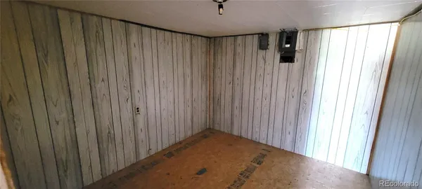a view of a hallway with wooden shelves