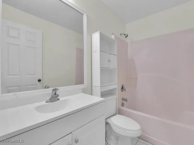 a bathroom with a sink toilet vanity and shower