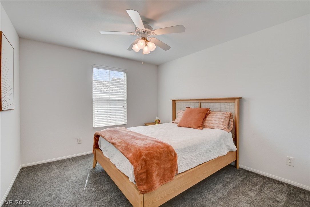 484 Filaree Place Henderson, NV 89015 - Photo 35 of 71 This cozy bedroom features plush carpeting and abundant natural light, creating a serene personal retreat.