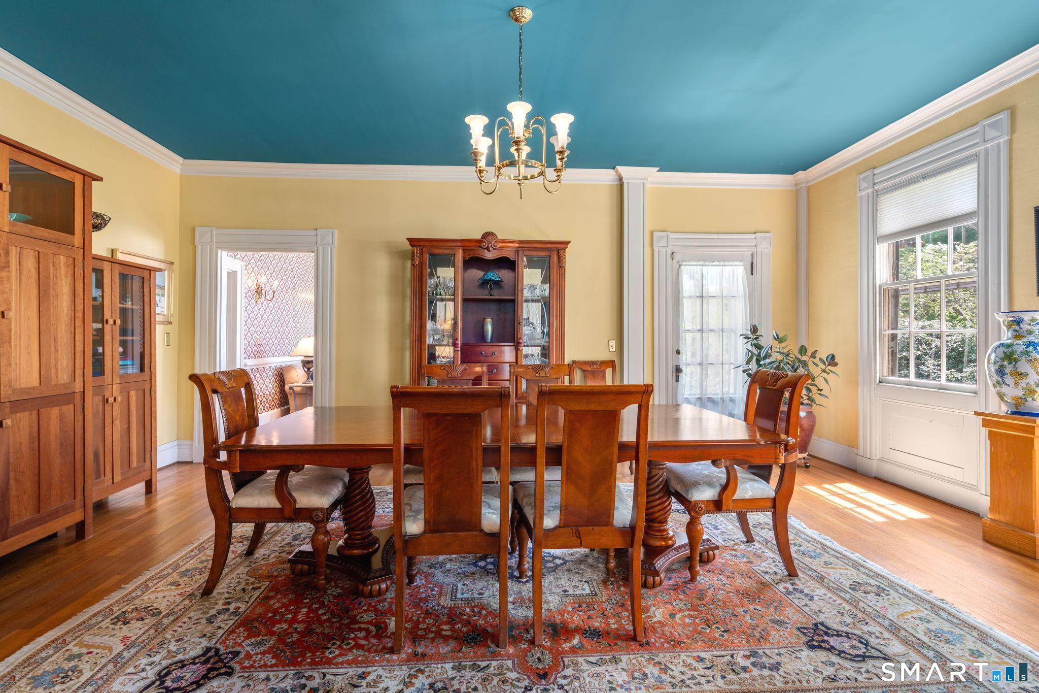 52 South Main Street Suffield, CT 06078 - Photo 15 of 40 a view of a dining room with furniture and chandelier