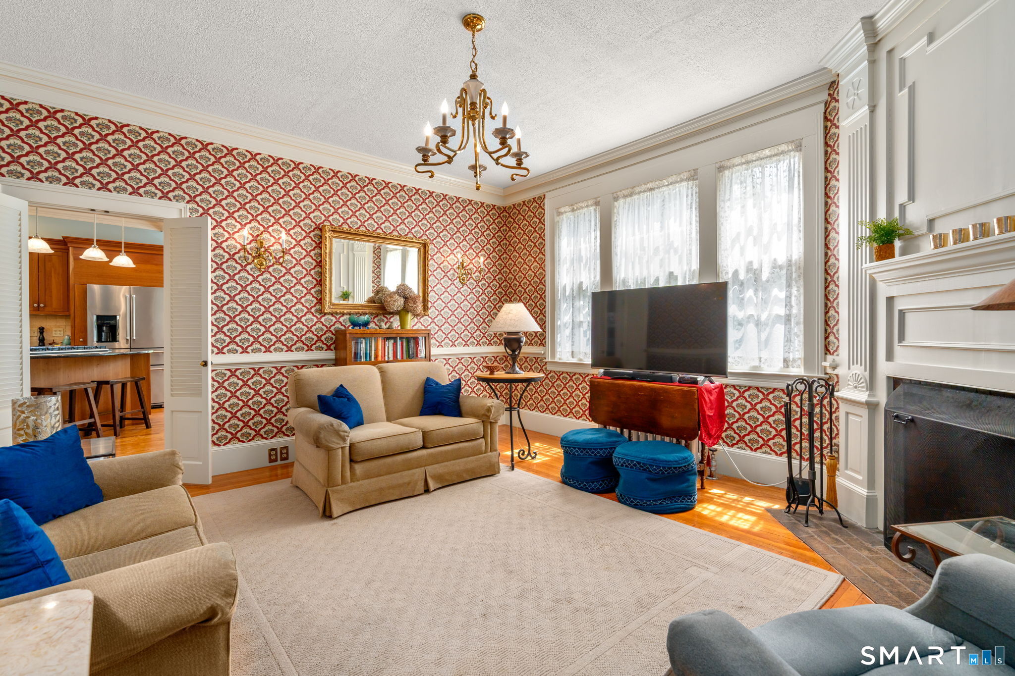 52 South Main Street Suffield, CT 06078 - Photo 16 of 40 a living room with furniture a fireplace and a flat screen tv