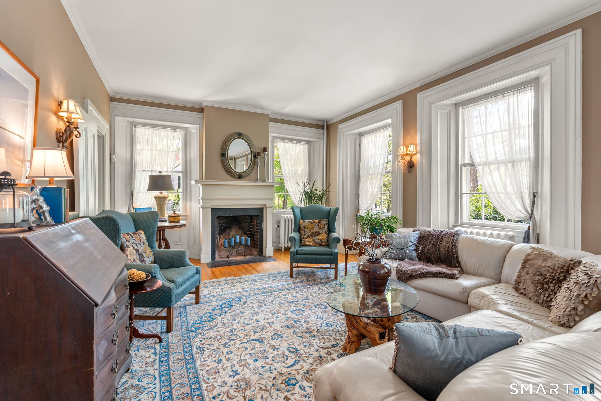 52 South Main Street Suffield, CT 06078 - Photo 17 of 40 a living room with furniture a large window and a fireplace