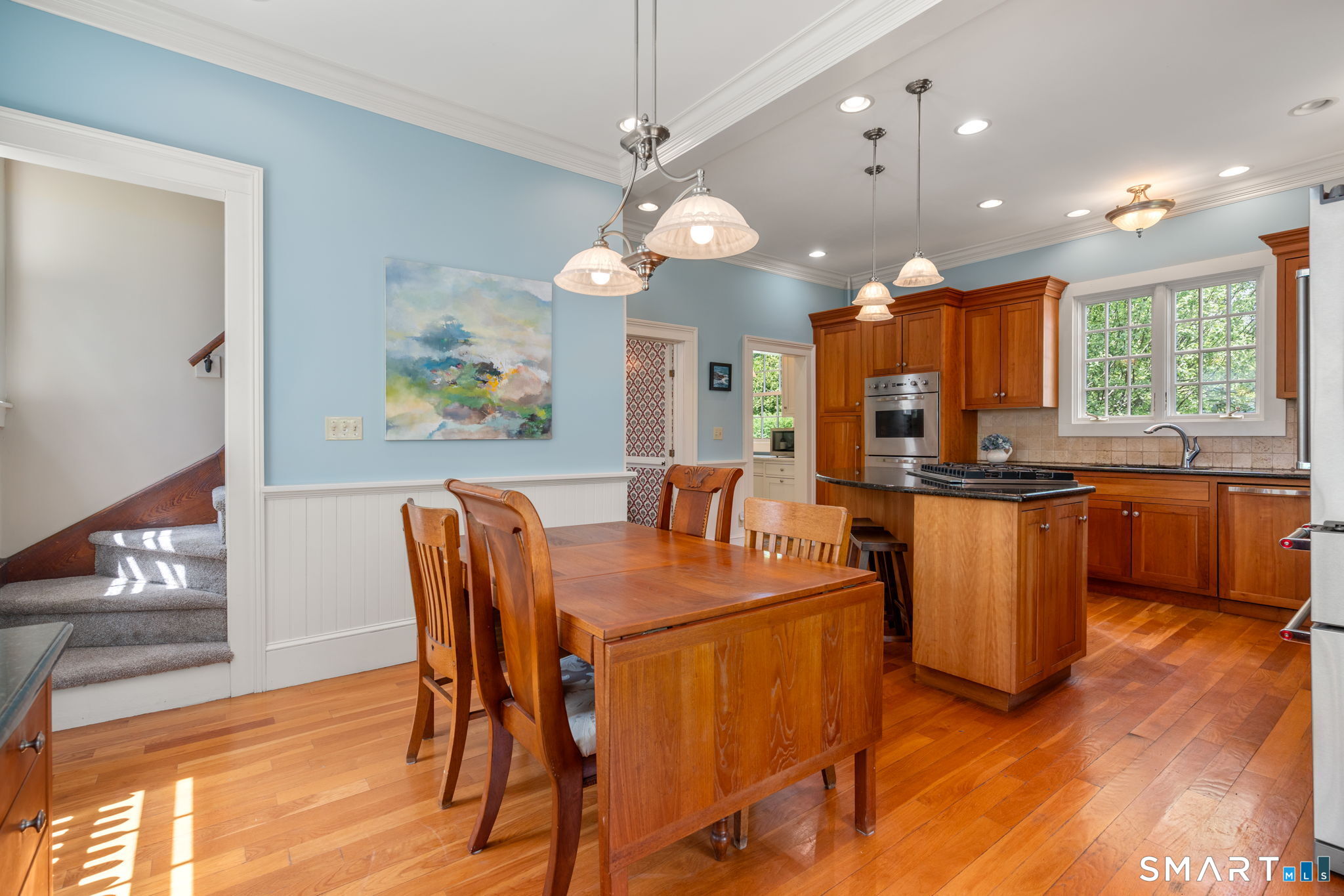 52 South Main Street Suffield, CT 06078 - Photo 4 of 40 a view of a dining room with furniture a kitchen and chandelier