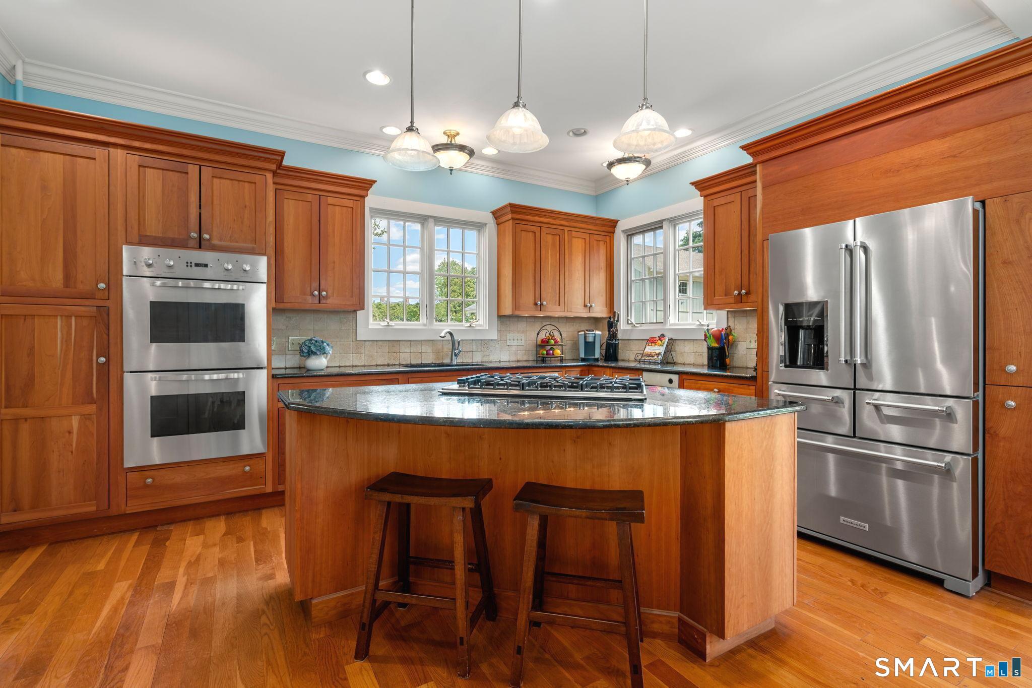 52 South Main Street Suffield, CT 06078 - Photo 5 of 40 a kitchen with stainless steel appliances granite countertop a refrigerator a stove a sink dishwasher and white cabinets with wooden floor