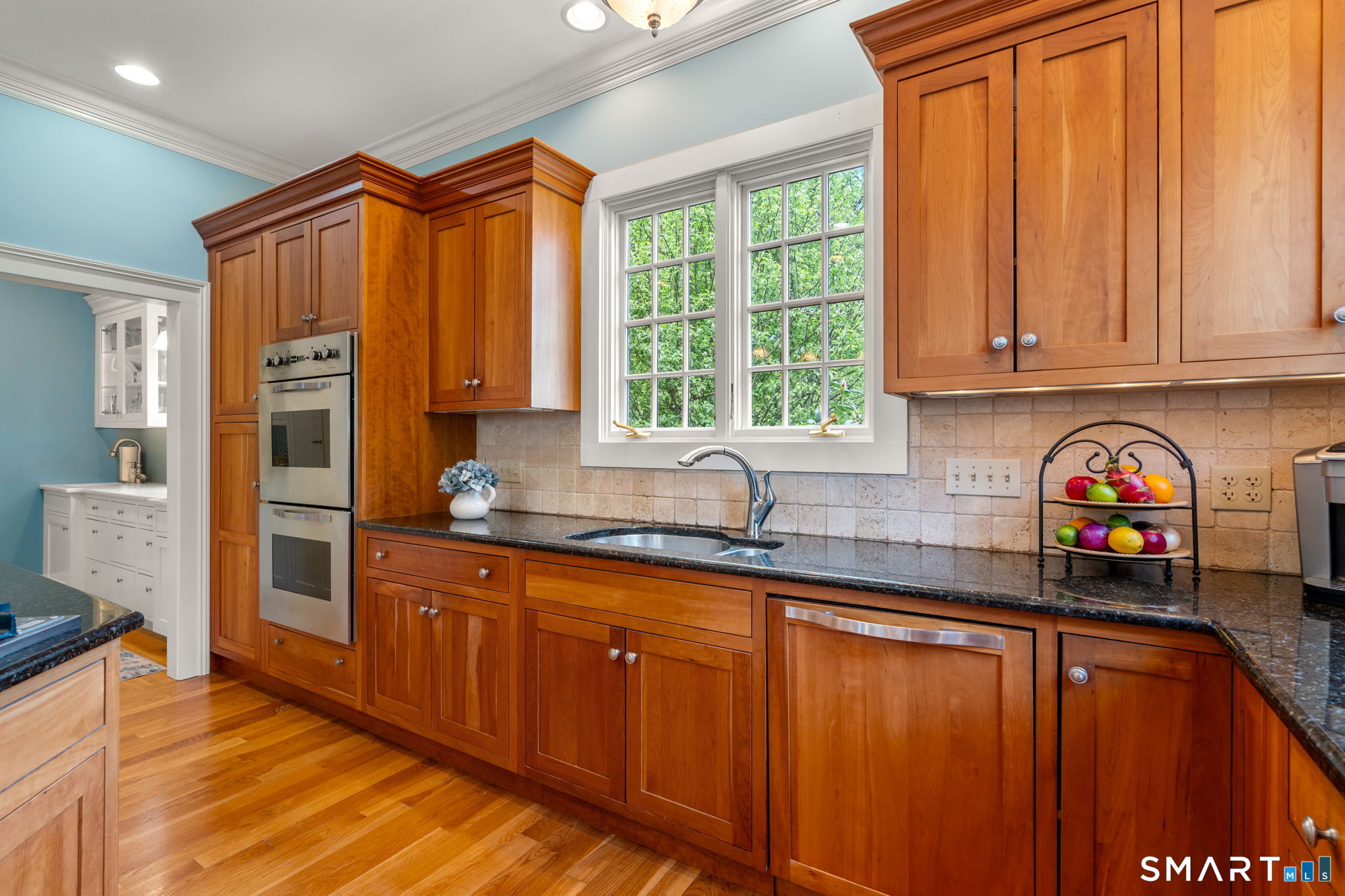 52 South Main Street Suffield, CT 06078 - Photo 10 of 40 a kitchen with stainless steel appliances wooden cabinets a sink and a microwave