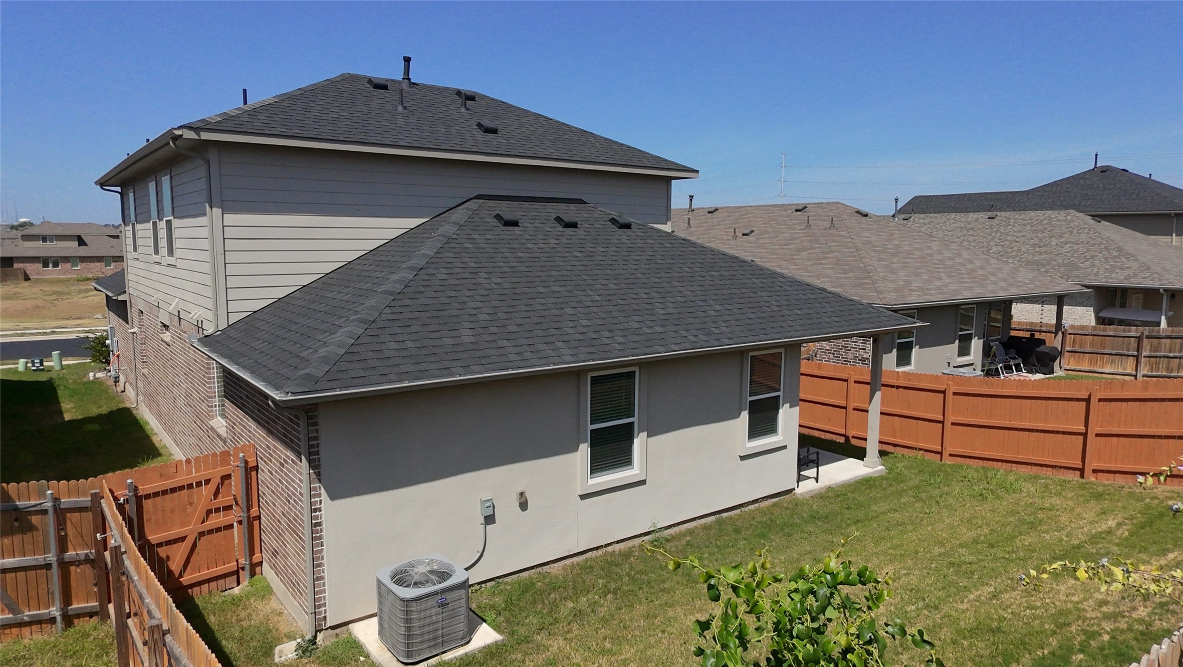 129 Saide Street Georgetown, TX 78626 - Photo 31 of 36 Fenced backyard spaces frame a two-story residence with a classic shingle roof layout.