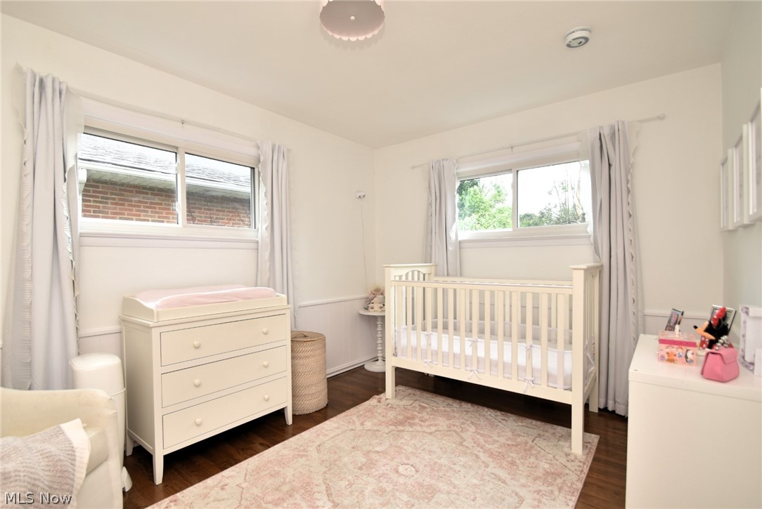 1174 Haverston Road Cleveland, OH 44124 - Photo 9 of 21 Bedroom with dark hardwood / wood-style flooring and a crib