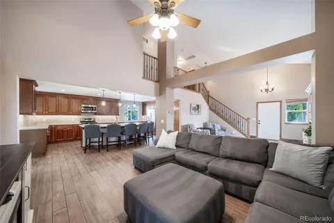 a living room with furniture and a chandelier