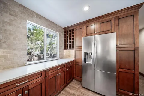 a kitchen with stainless steel appliances granite countertop a refrigerator and a sink
