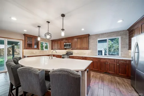 a large kitchen with a table and chairs