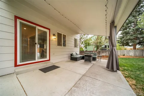 a outdoor living space with furniture and a rug