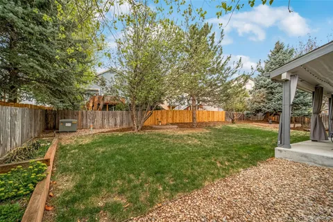 a front view of a house with yard patio and green space