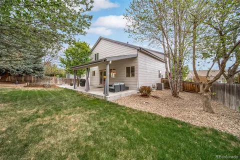 a house view with a sitting space and garden
