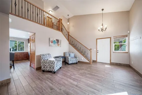 a view of entryway and hall with wooden floor