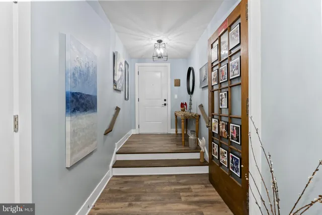 a view of entryway and hall with wooden floor