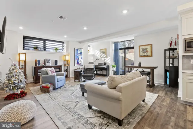 a living room with furniture and a fireplace