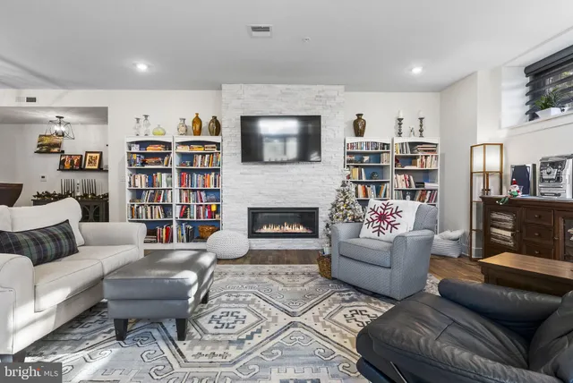 a living room with lots of furniture and kitchen view