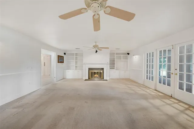 a view of an empty room with a fireplace