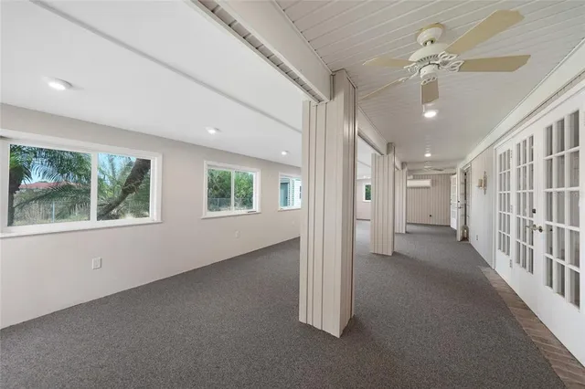 a view of a big room with windows and entryway