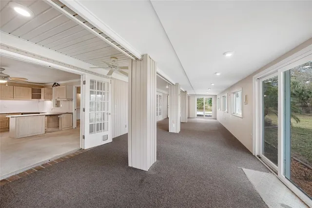 a large white kitchen with white cabinets and stainless steel appliances