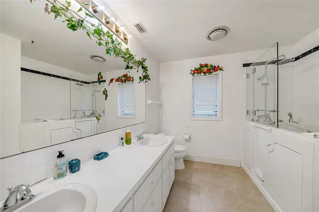 a bathroom with a double vanity sink mirror double and shower