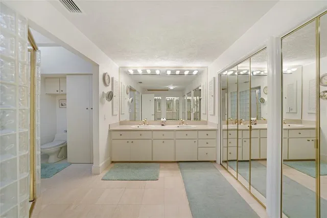 a spacious bathroom with a shower sink mirror and shower