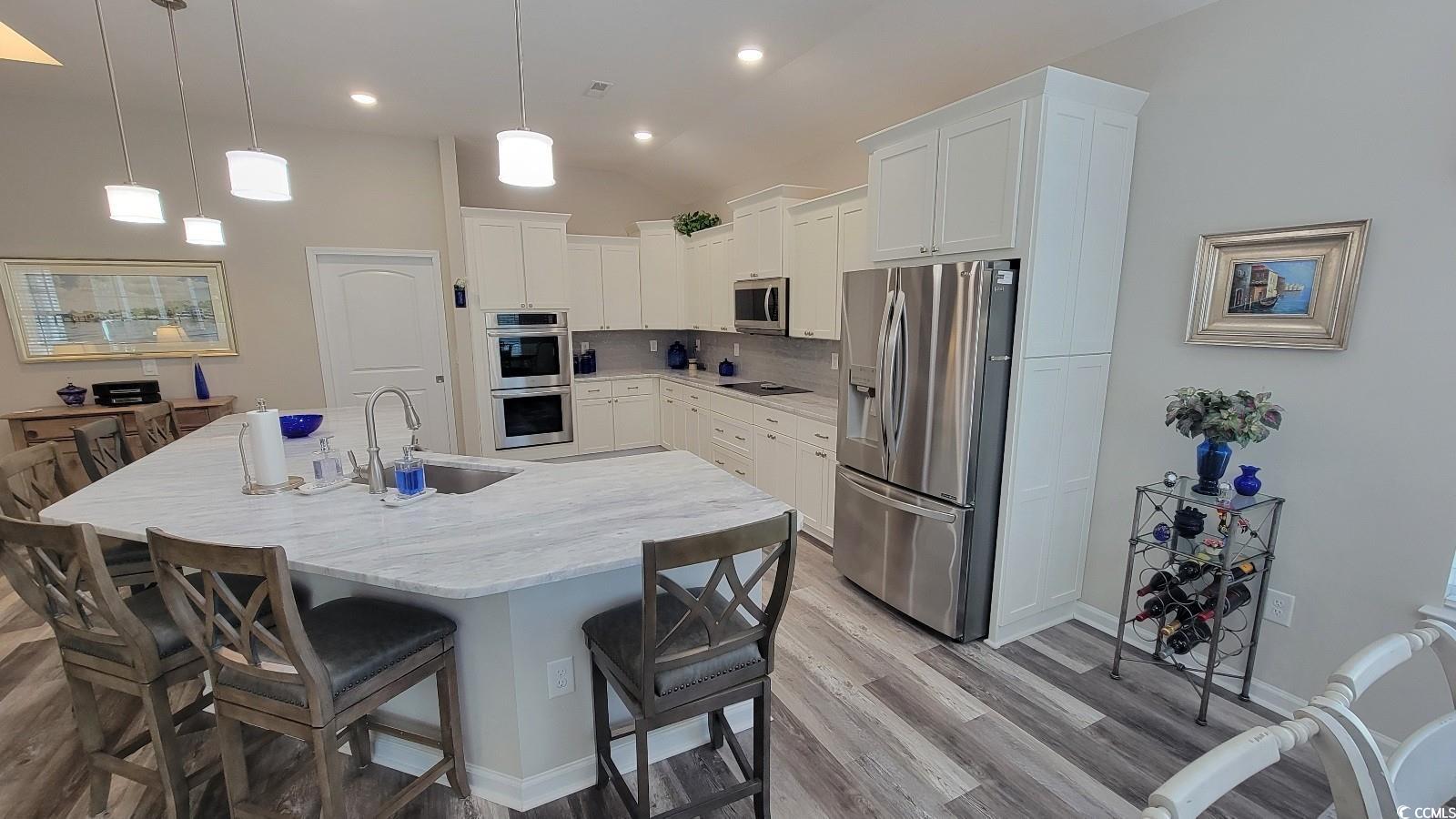 372 Leste Road Myrtle Beach, SC 29588 - Photo 6 of 25 Kitchen featuring sink, white cabinetry, a kitchen
