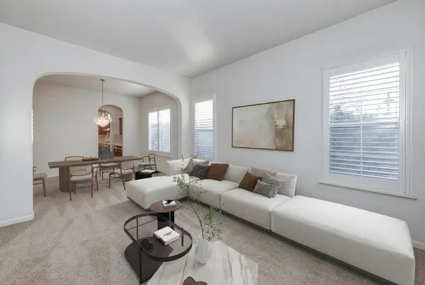 a living room with furniture a fireplace and a window