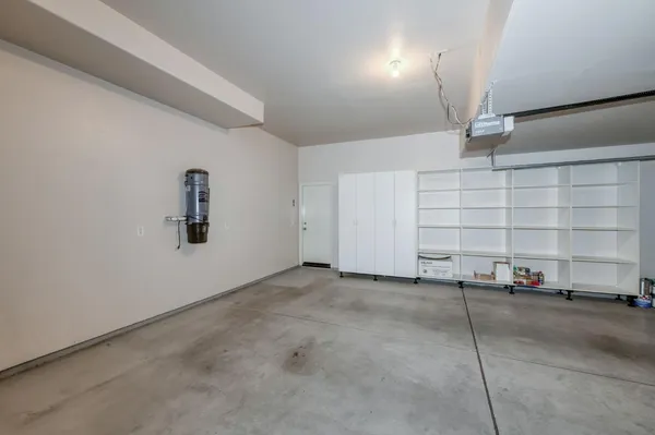 an aerial view of a city with lots of residential buildings ocean and mountain view in back