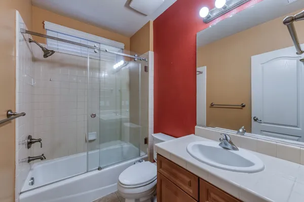 a bathroom with a sink mirror and vanity
