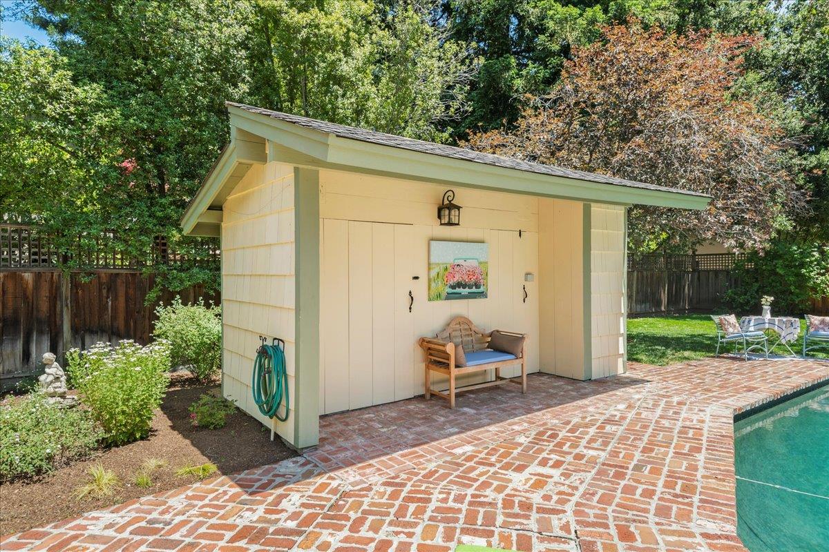 32 Maple Avenue Atherton, CA 94027 - Photo 43 of 52 a view of a patio with table and chairs near a yard with wooden fence