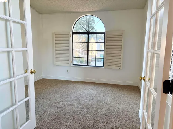 an empty room with windows and closet