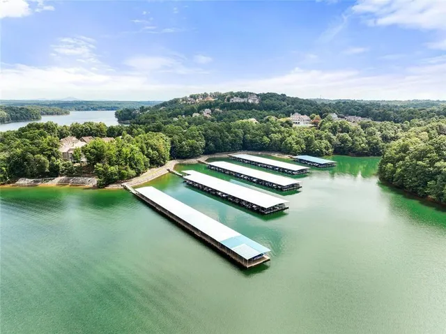 an aerial view of a house with pool lake view and mountain view