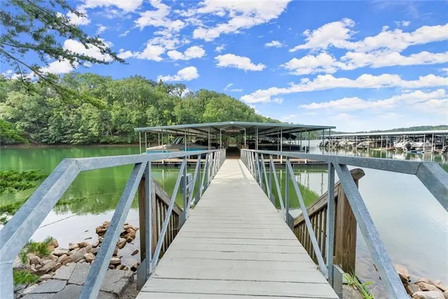 a view of a lake with a floor to ceiling window and wooden fence