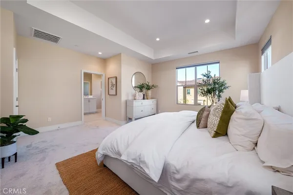 a spacious bathroom with a double vanity sink a mirror and a bathtub