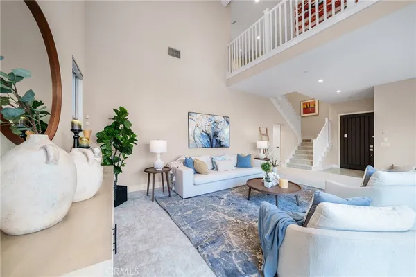 a living room with furniture and a chandelier