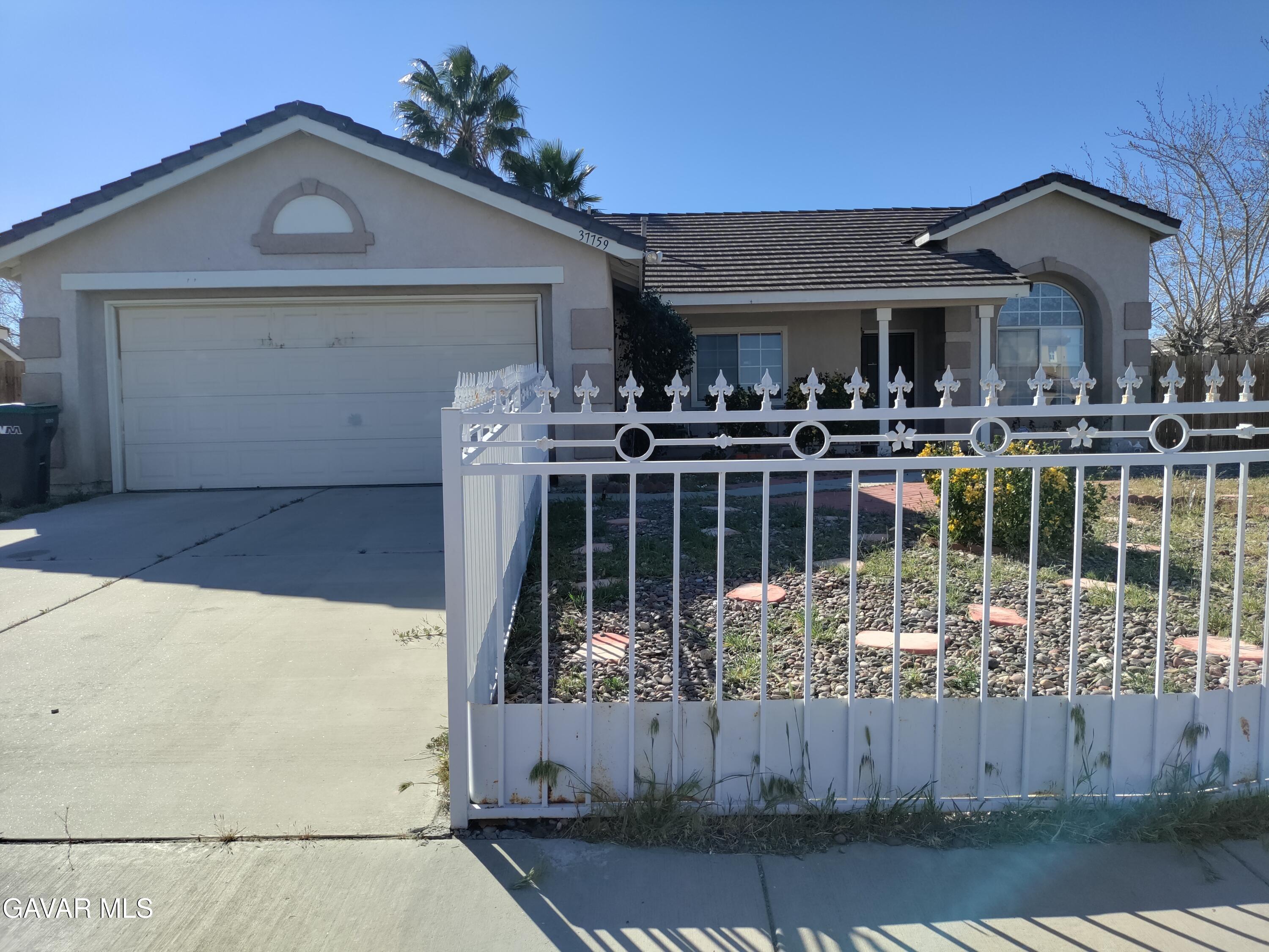 37759 67th Street East Palmdale, CA 93552 - Photo 1 of 27 a view of a house with wooden deck and furniture