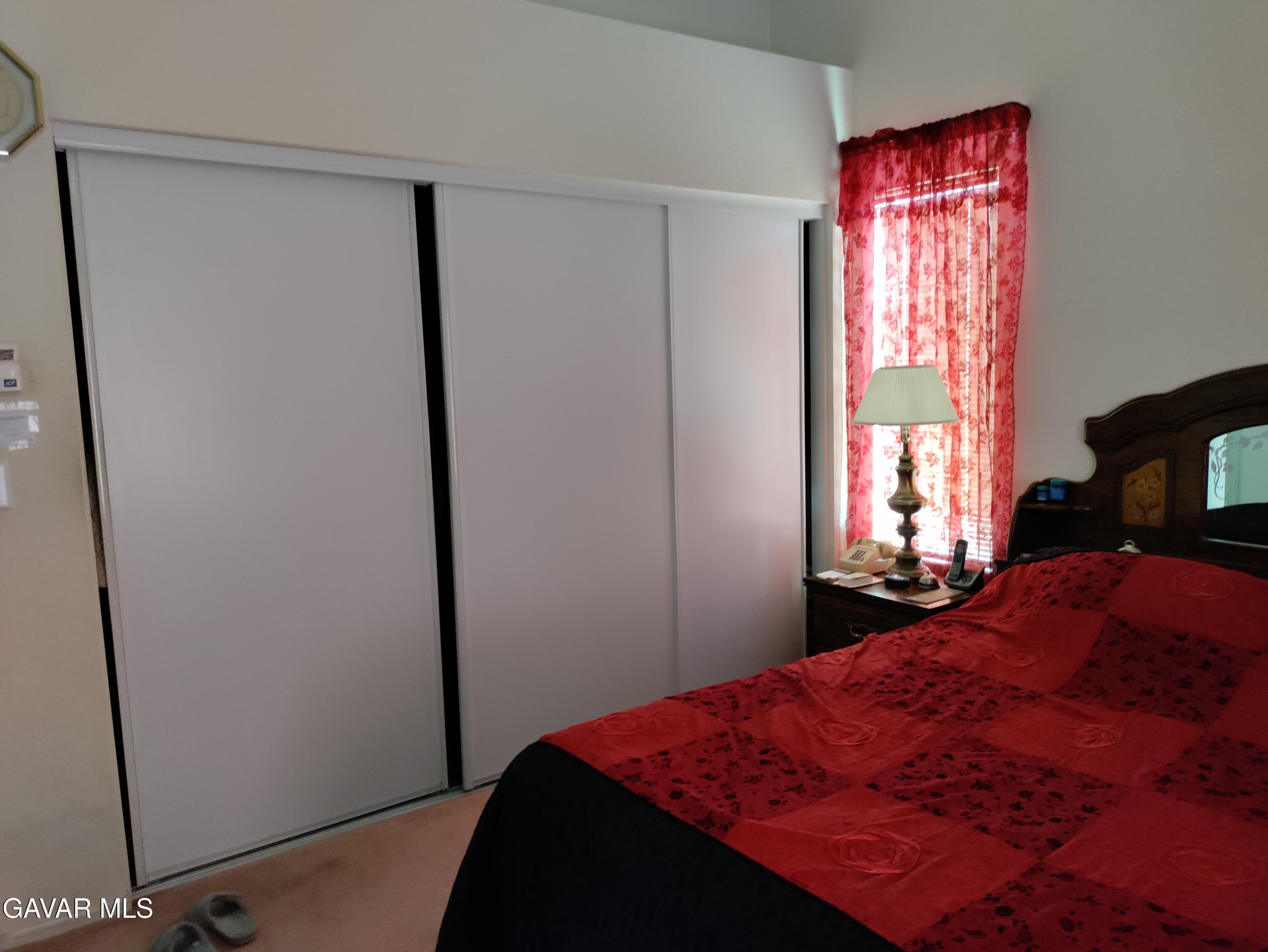 37759 67th Street East Palmdale, CA 93552 - Photo 12 of 27 a bedroom with a bed and a window
