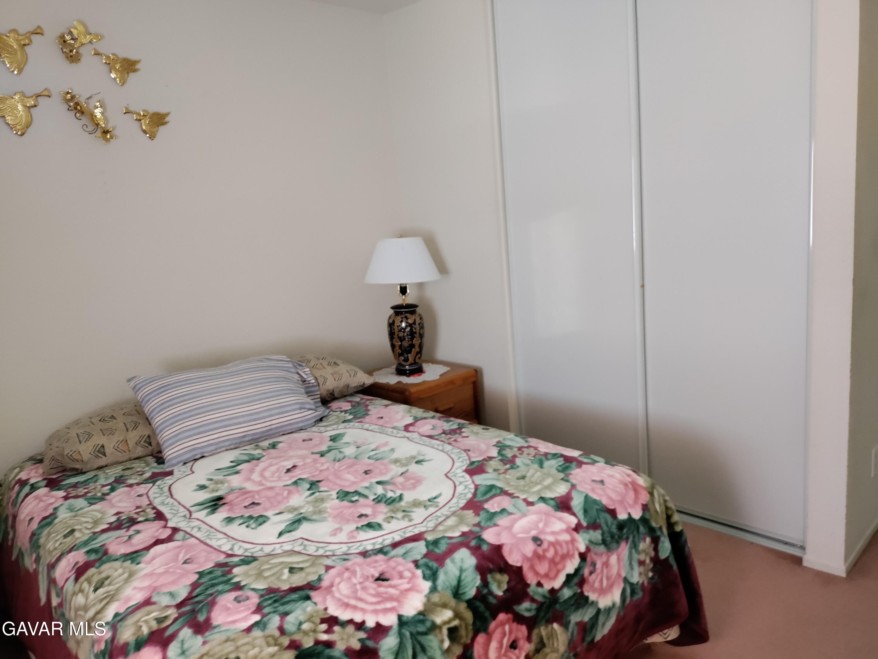 37759 67th Street East Palmdale, CA 93552 - Photo 15 of 27 a bedroom with a bed and a mirror