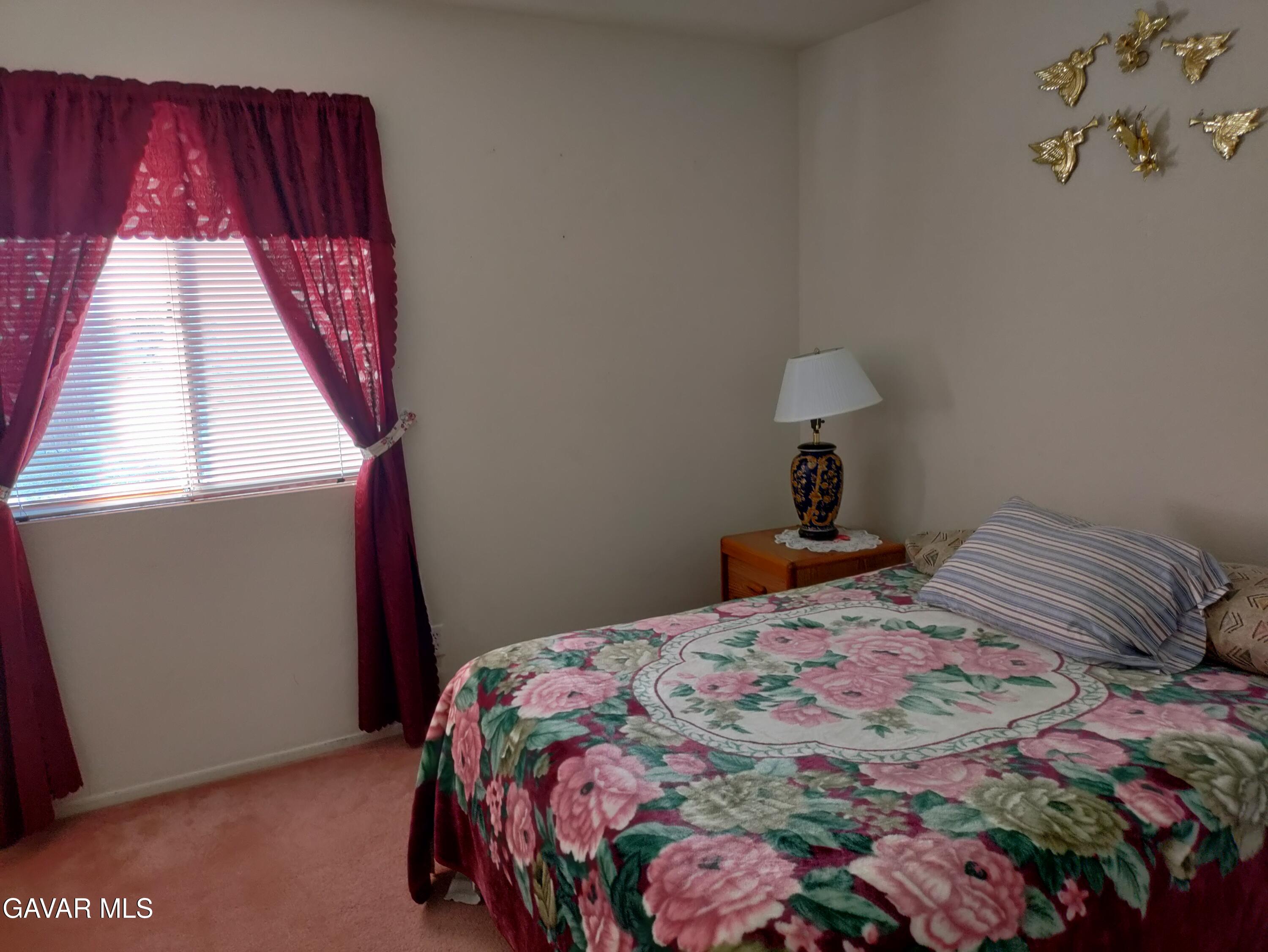 37759 67th Street East Palmdale, CA 93552 - Photo 16 of 27 a bedroom with a bed and a window