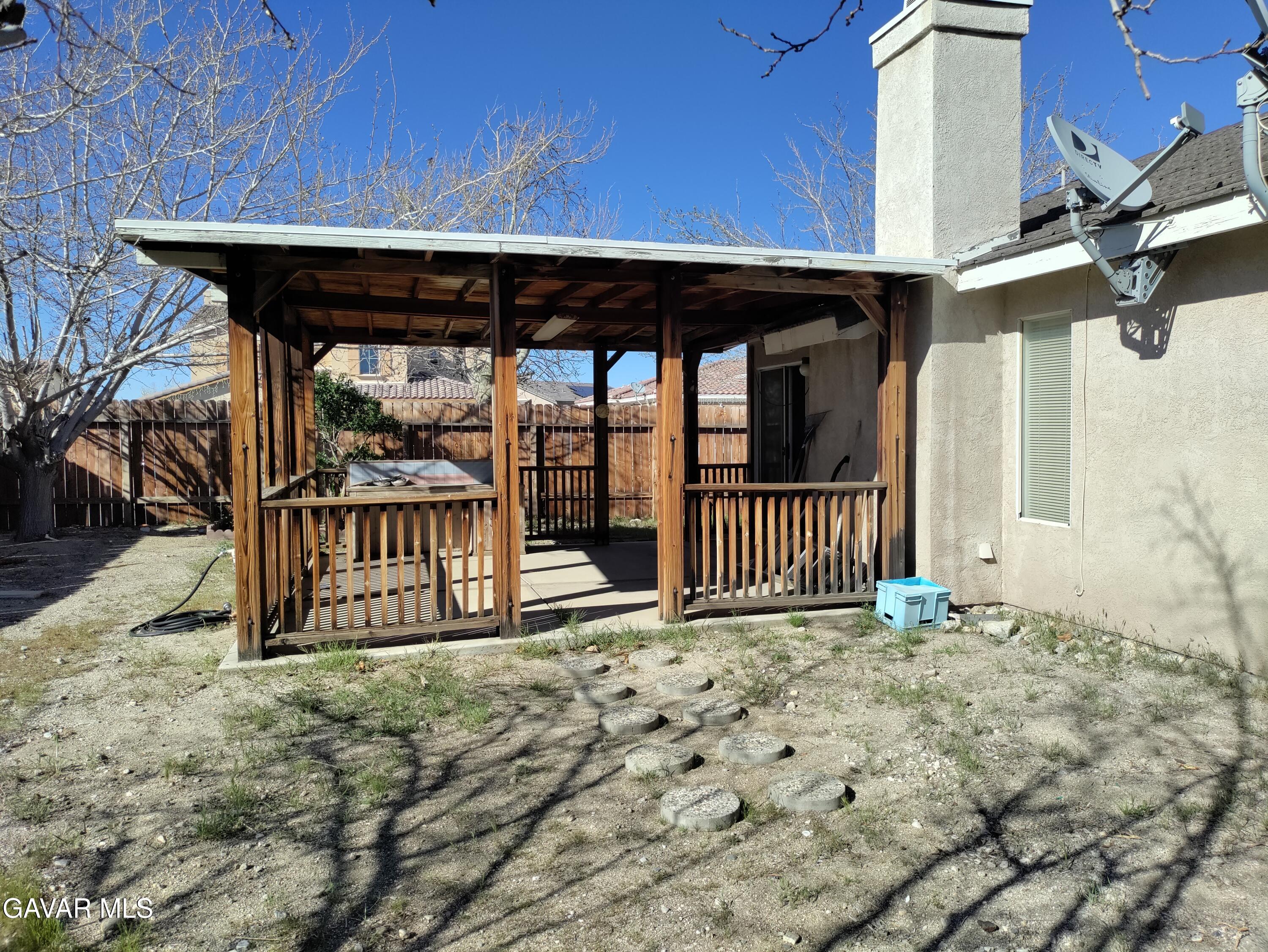 37759 67th Street East Palmdale, CA 93552 - Photo 22 of 27 a view of a porch with a small yard